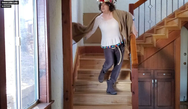 Nicole dancing down the stairs in costume