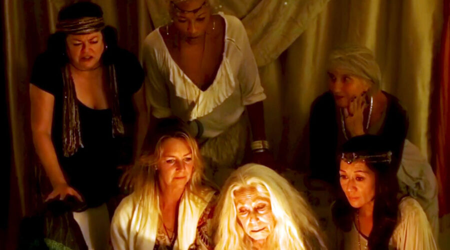 Six women of the Lineage Tribe cast acting on the set