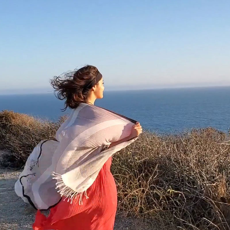 Women looking over a cliff with wind blowing