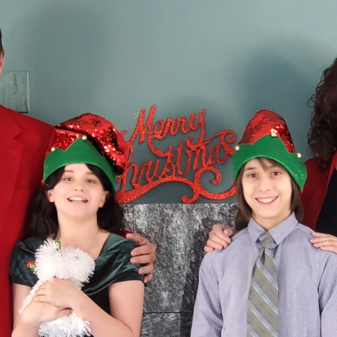 Family Christmas picture with husband, daughter, son, and wife