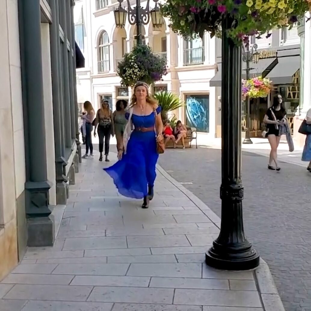 Young woman walking down a street