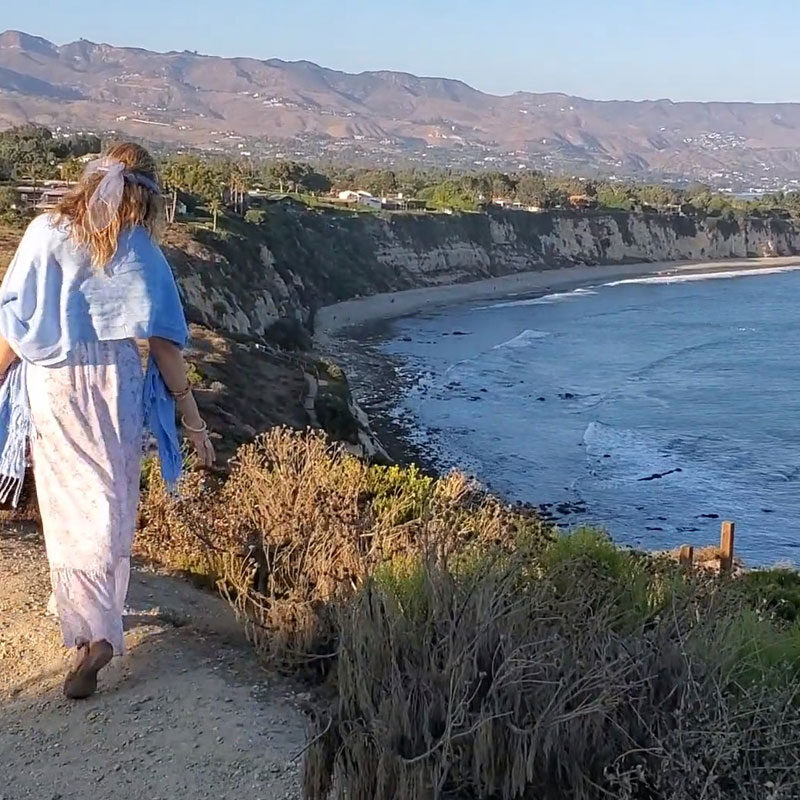 Girl walking along a cliff
